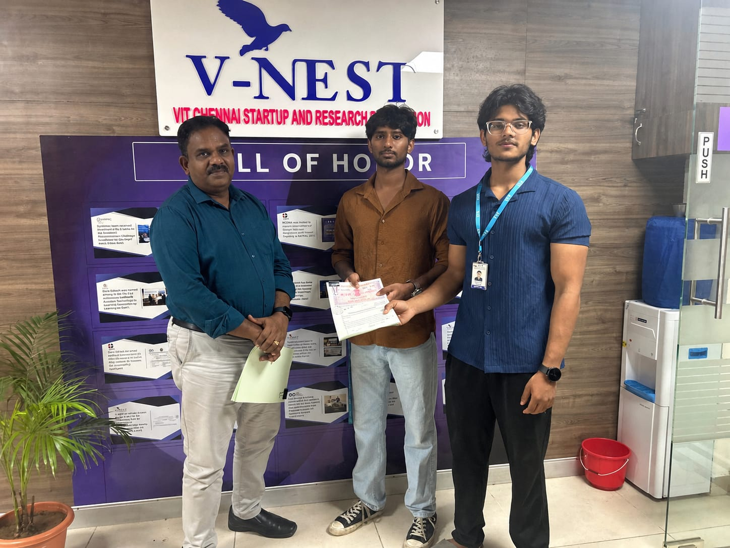 Two Mirai team members receiving a recognition document at V-NEST, the VIT Chennai startup and research foundation